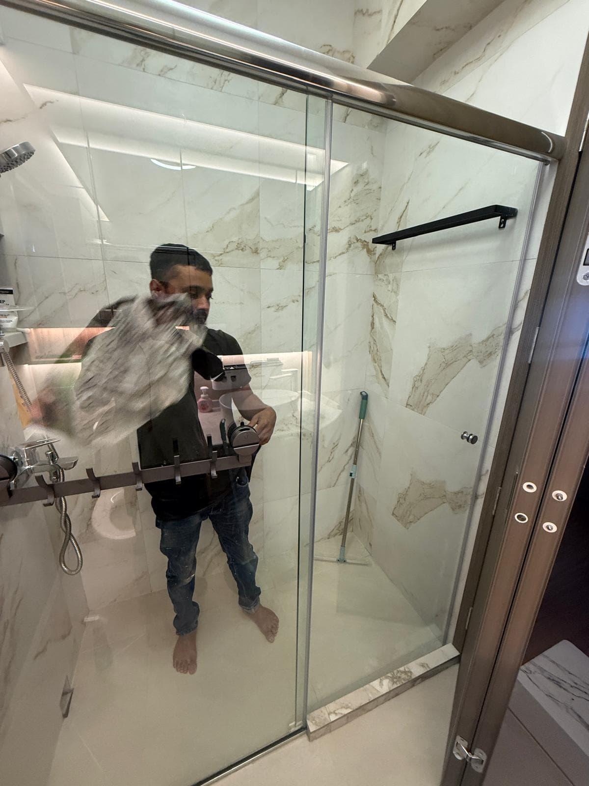 Replacement of a broken shower screen glass panel in a bathroom