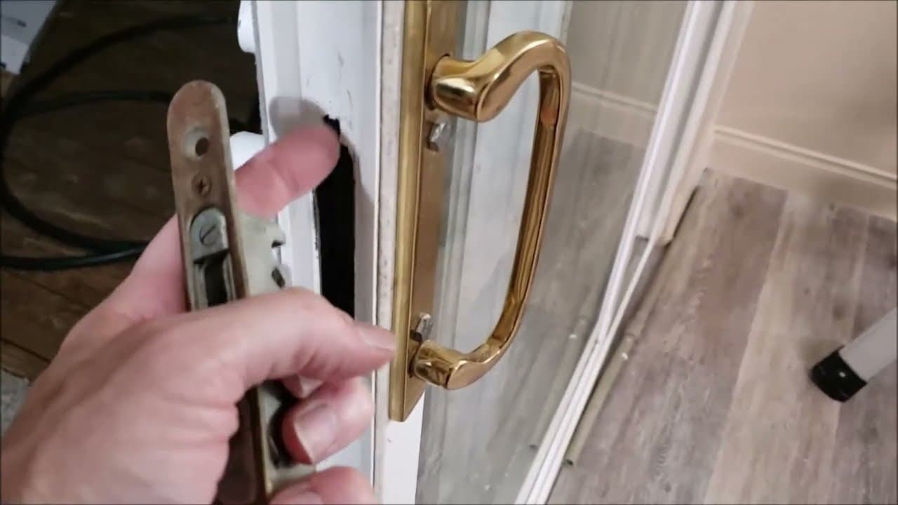 Installing a new stainless steel handle on a glass door