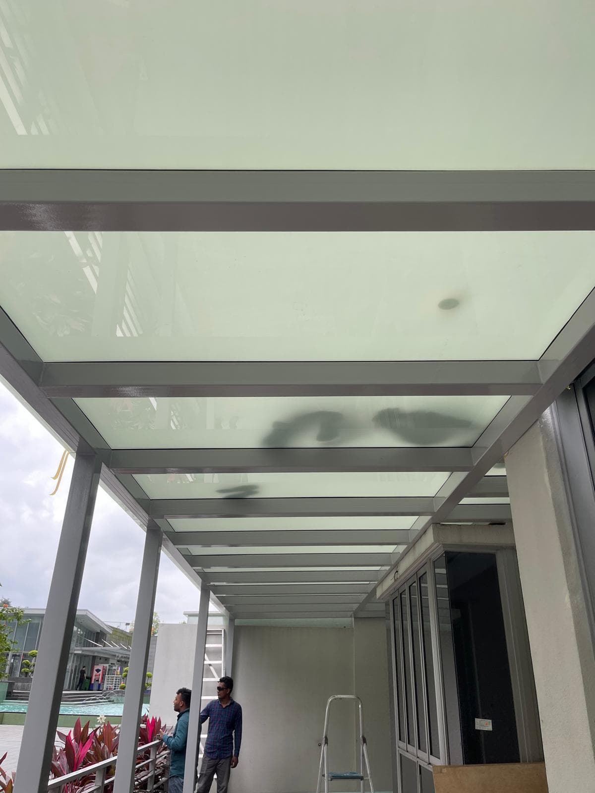 Applying clear adhesive to a small crack in a polycarbonate canopy