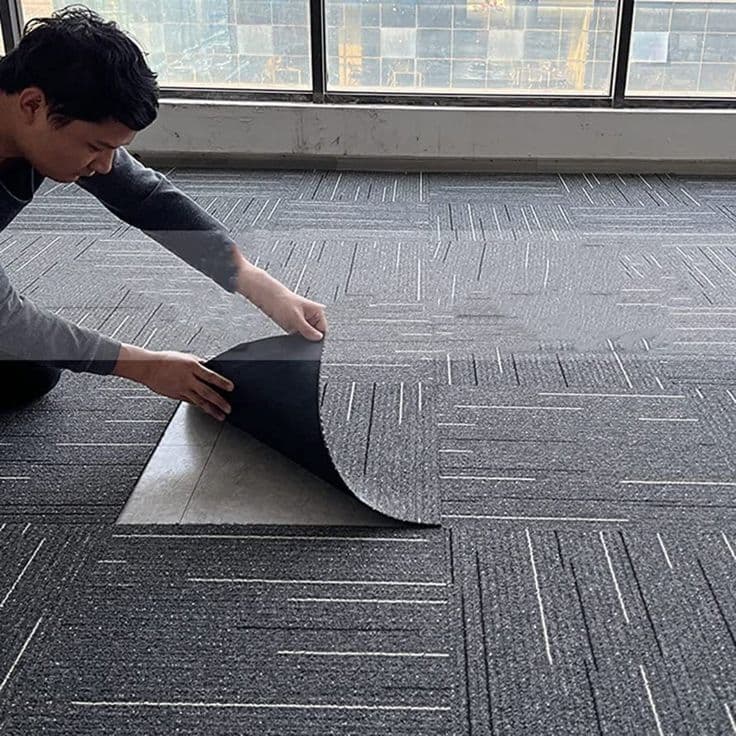 Laying carpet tiles in an office meeting room