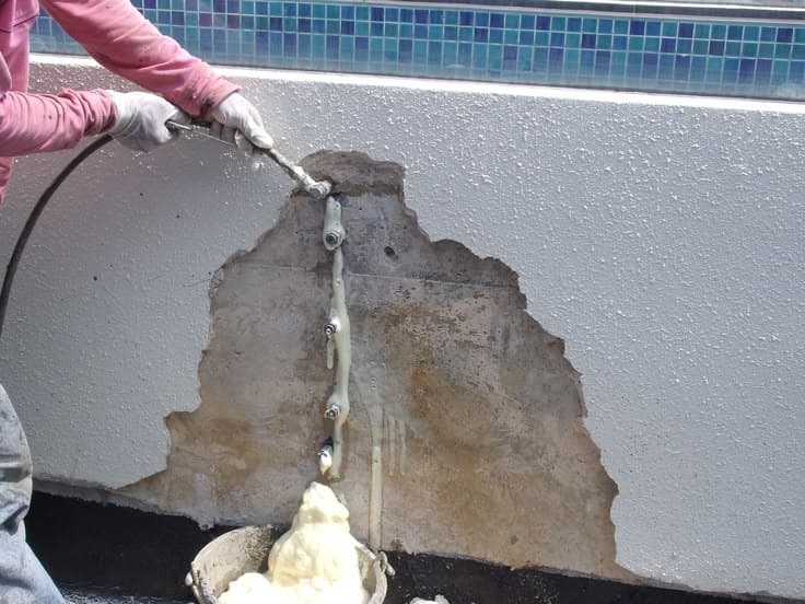 PU injection machine sealing a ceiling crack in a HDB flat