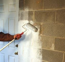 Applying crystalline waterproofing to a basement wall