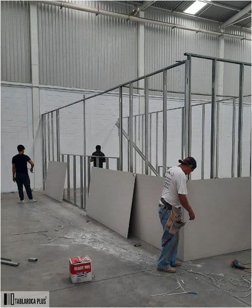 Workers removing drywall partitions during an office reinstatement