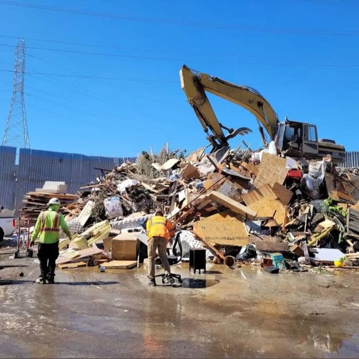 Workers dismantling old furniture for disposal