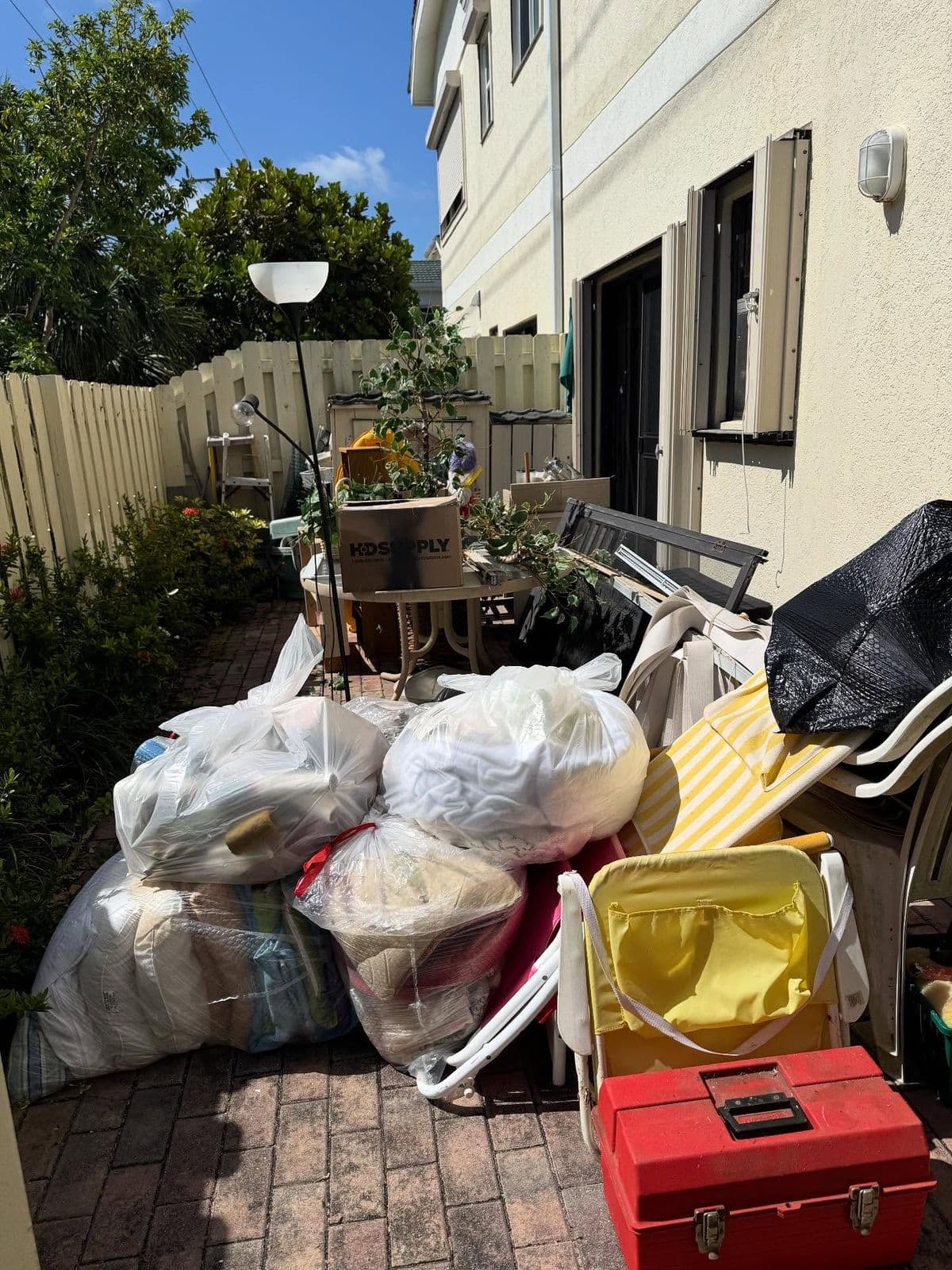Clearing a pile of renovation debris into waste bags