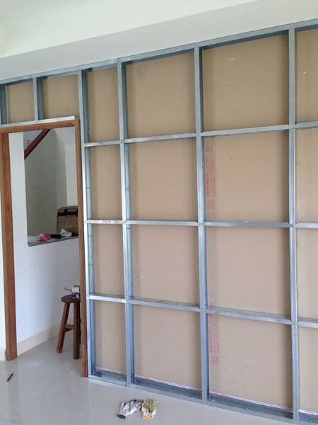 New drywall partition frame being installed in a room
